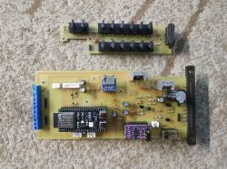 Two PCBs with electronic components placed on a beige carpet