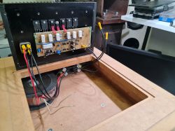 Otwarta obudowa subwoofera z widoczną elektroniką.