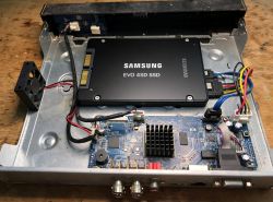 Samsung EVO 4SD SSD installed inside open device enclosure with visible motherboard