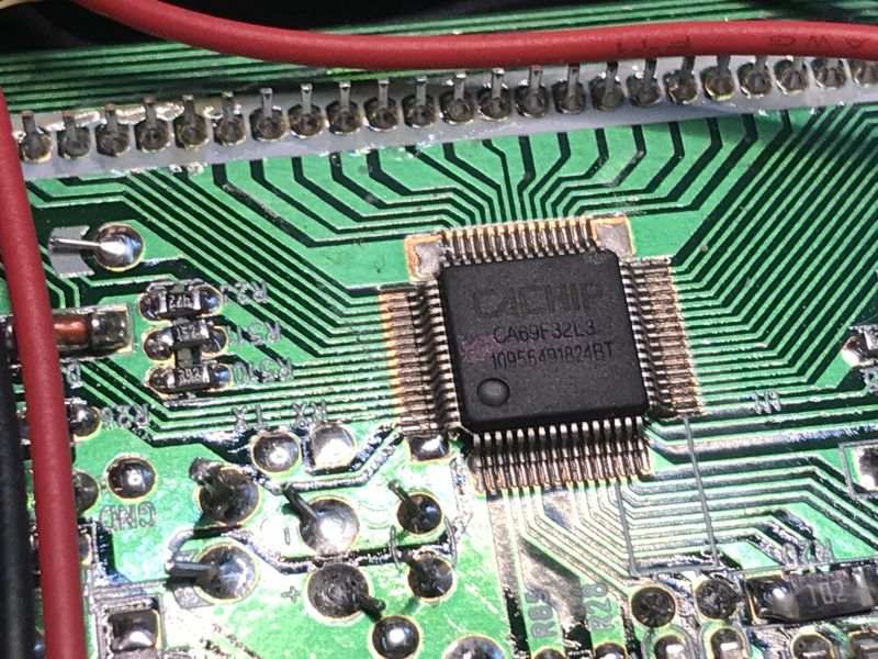 Close-up of CA69F32L3 microcontroller on a green PCB with dense traces and red wires