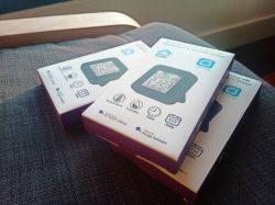 Boxes of smart temperature and humidity sensors lying on a couch.