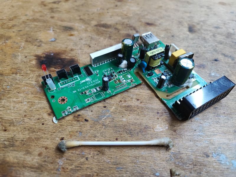 Modified Satellite Tuner Board Dismantled and modified satellite tuner board on a wooden table, with several removed components and the SCART removed.