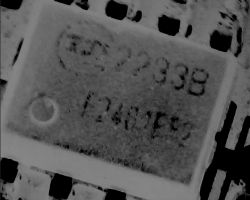 Close-up of an integrated circuit with barely visible 2233B marking.