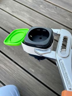 Electrical plug held in a pipe wrench with a cardboard spacer.