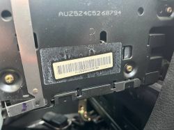 Serial number label on the back of a black electronic unit