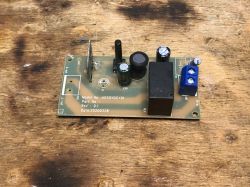 Printed Circuit Board with Electronic Components Printed circuit board with various electronic components on a wooden background.