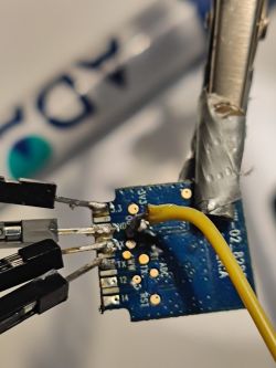 Close-up of a circuit board with soldered wires.