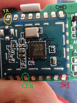 Close-up of a circuit board with labeled TX, RX, GND, CEN, and 3V3 pins.