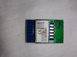 CB2S electronic module on a small PCB Green circuit board with a shielded module labeled “Model: CB2S” on a light fabric background