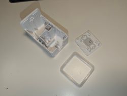 Plastic casing parts on a table Three plastic casing parts for an electrical device on a white table.