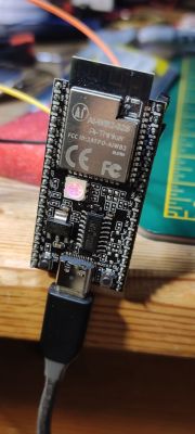 BL602 AI-Thinker development board with a connected USB-C cable.