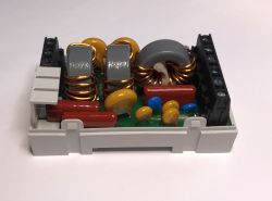 Internal view of an EMI filter with visible coils and capacitors.