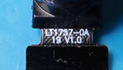 Close-up of a camera ribbon marked LT1757-QA 19 V1.0 on a blue background