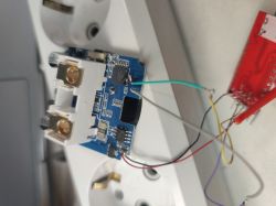 Electronic module with connected wires next to a power strip with sockets