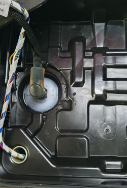 Image of the vehicle's container interior with leaking fluid near the pump.