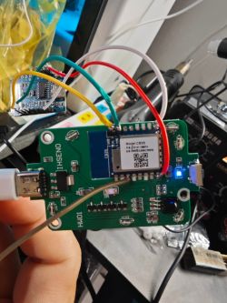 The image shows a printed circuit board with a mounted CB3S module, connected with multicolored wires. The board includes a USB port and an LED.