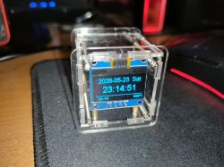 Small DIY clock in a clear case with a display showing date and time