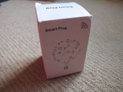 Smart Plug Packaging Smart plug packaging on a carpet.