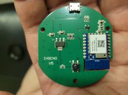 Circular Printed Circuit Board with Electronic Components A hand holding a circular printed circuit board with electronic components.