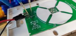 Close-up of a circuit board with attached probe wires.