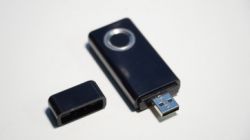 Black USB flash drive with fingerprint recognition feature.