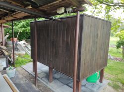 Wooden structure being installed in a garden.