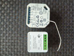 Two smart switch modules with labels and connectors on the surface.