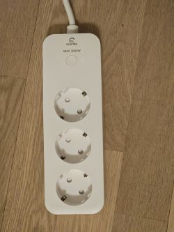 Eightree WiFi Power Strip with Three Sockets White Eightree power strip with three sockets on a wooden floor.