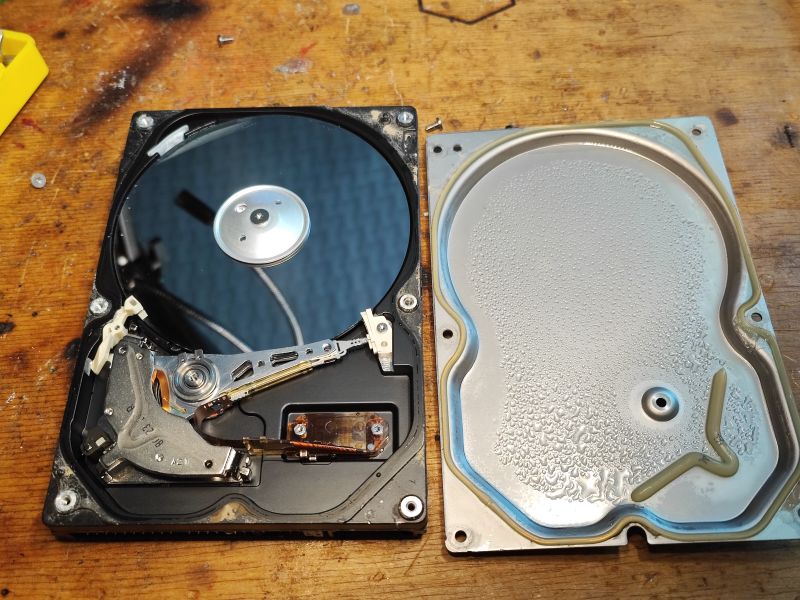 Flooded Hard Drive: Internal View Interior of a flooded hard drive with visible moisture.