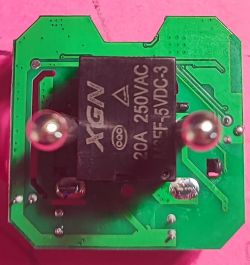 Interior of a Smart Plug with XGN Relay Image of the interior of a smart plug featuring an XGN relay on a green circuit board.