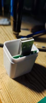 Micro Smart USB Switch in Casing Circuit board of a micro smart USB switch in a plastic casing.