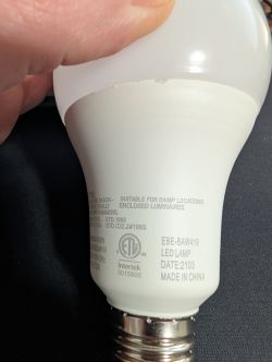 LED bulb with manufacturer markings and certifications.