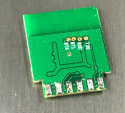 Close-up of a green electronic module XY-WE2S-A V1.1 with visible tracks and soldering points.