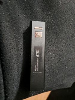 Czarny adapter WiFi z napisem Endoscope HD 1200P leżący na ciemnym tle.