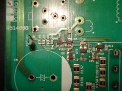 Close-up of a circuit board with component labels and electronic elements.