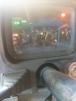 Deska rozdzielcza traktora New Holland z włączonymi kontrolkami.
