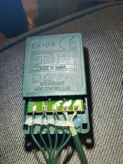 Close-up of green EK-04 controller with visible wires and PCB components.
