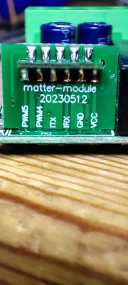 Close-up of a small electronic module labeled matter-module 2023051.2 with terminals marked PWM5, PWM4, TX, RX, GND, VCC.