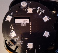 Image of a circular printed circuit board with various electronic components such as LEDs and capacitors.