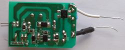 Green printed circuit board with electronic components and wires.