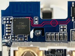Close-up of a circuit board with a T34 chip and red lines marking paths leading to a circle.