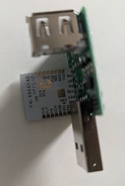 Close-up of disassembled USB Type-A adapter with Wi-Fi module and labeled pins