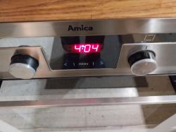 Amica Oven Control Panel Control panel of an Amica oven with visible knobs and a clock display.