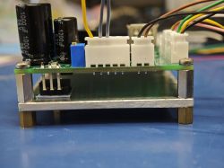 Tested power supply with soldered PCB components Front view of soldered PCB with capacitors and multiple wire connectors