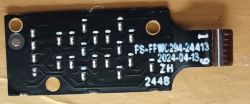 Small black circuit board with serial numbers and markings.