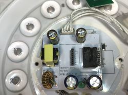 Close-up of the internal controller and power supply of an LED ceiling light.
