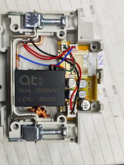 Image of the inside of a relay marked at 60A 250VAC COIL: 5VDC with visible wires and electronic components.