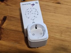 Smart Plug on Wooden Table White smart plug with packaging on a wooden table