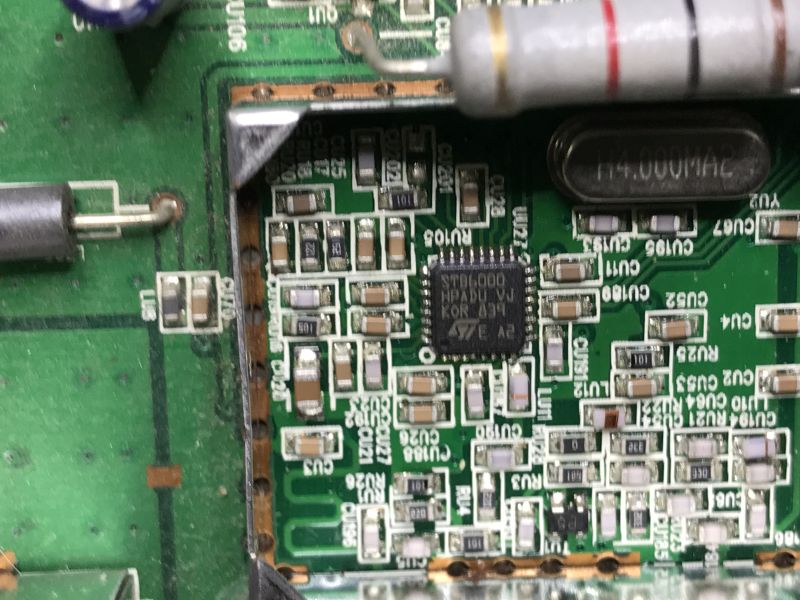 Close-up of STB6000 IC on green PCB with SMD components and 14 MHz quartz crystal