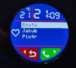Okrągły ekran smartwatcha z listą kontaktów, temperaturą 21°C i godziną 21:09